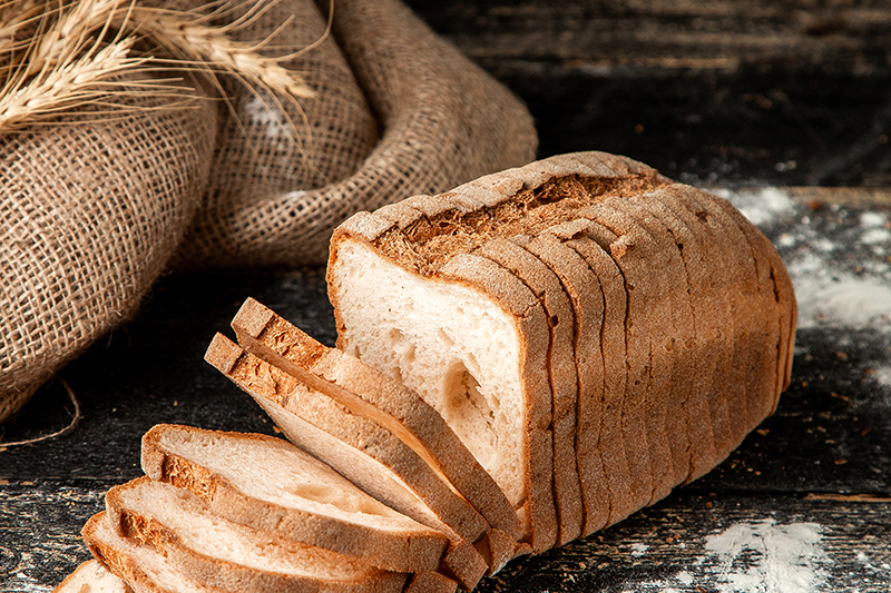 Whole wheat bread is darker in color than white bread. Whole wheat is varying shades of brown in color, while white is lighter in color. Whole wheat bread is made from grains that have not been under much processing. White is made from flour that is highly processed and refined.